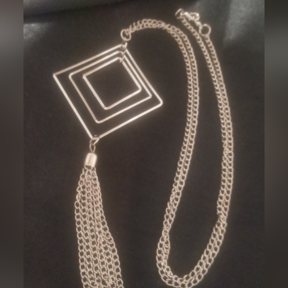 Long necklace chain tassel on a three tier square pendant. 24 inches long
